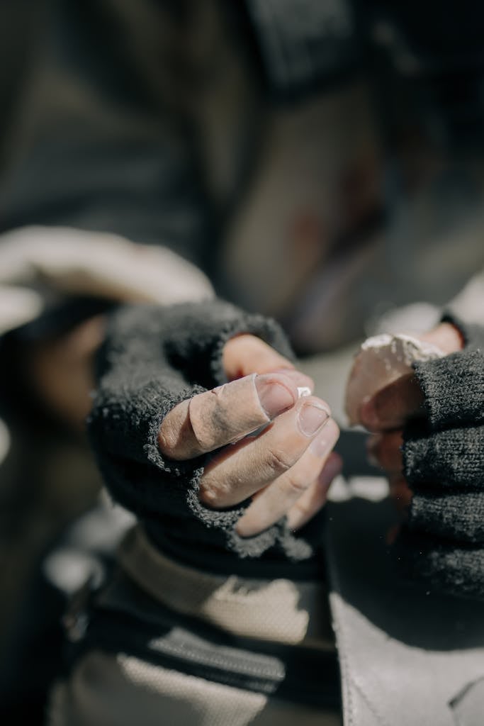 Person in Black Gloves Holding Hands