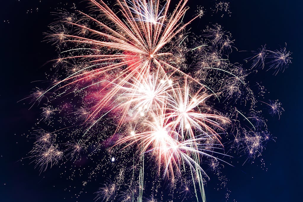 Colorful fireworks exploding in the night sky creating a festive atmosphere.