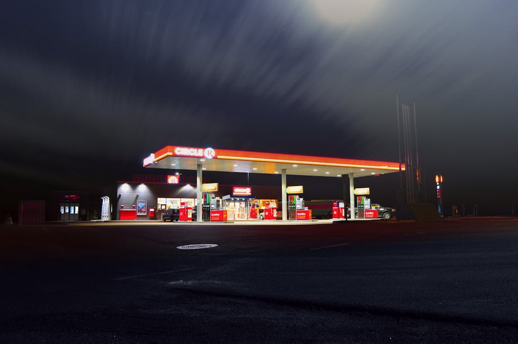 A brightly lit gas station in Norrtälje, Sweden, captured at night with a long exposure.