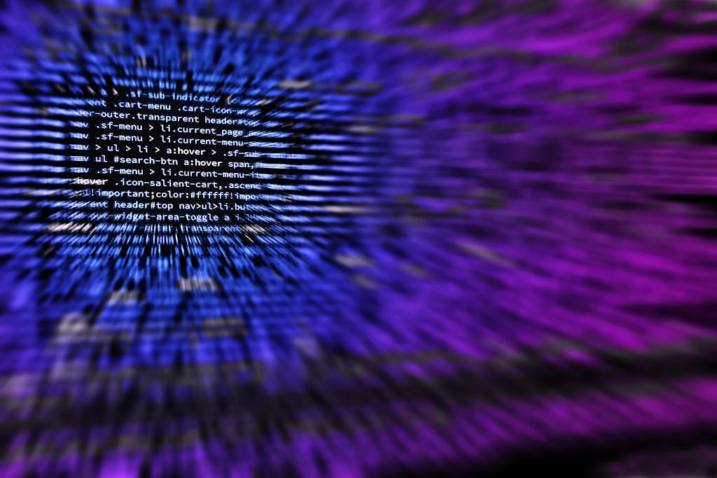 Dynamic abstract background featuring computer code in focus with blurred effect.