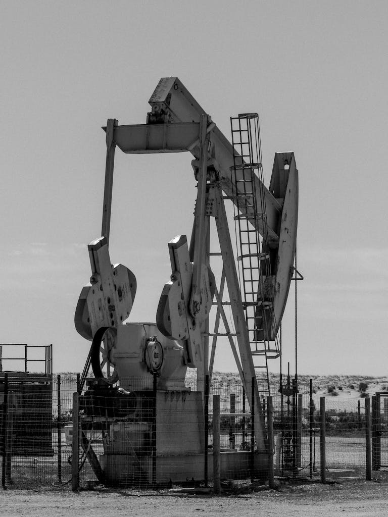 Monochrome image of an oil pump in rural Arcachon, France, capturing industrial essence.